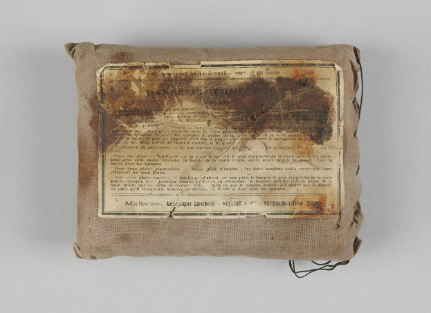 Kleines Erste-Hilfe-Set mit einem informativen Blatt obenauf.