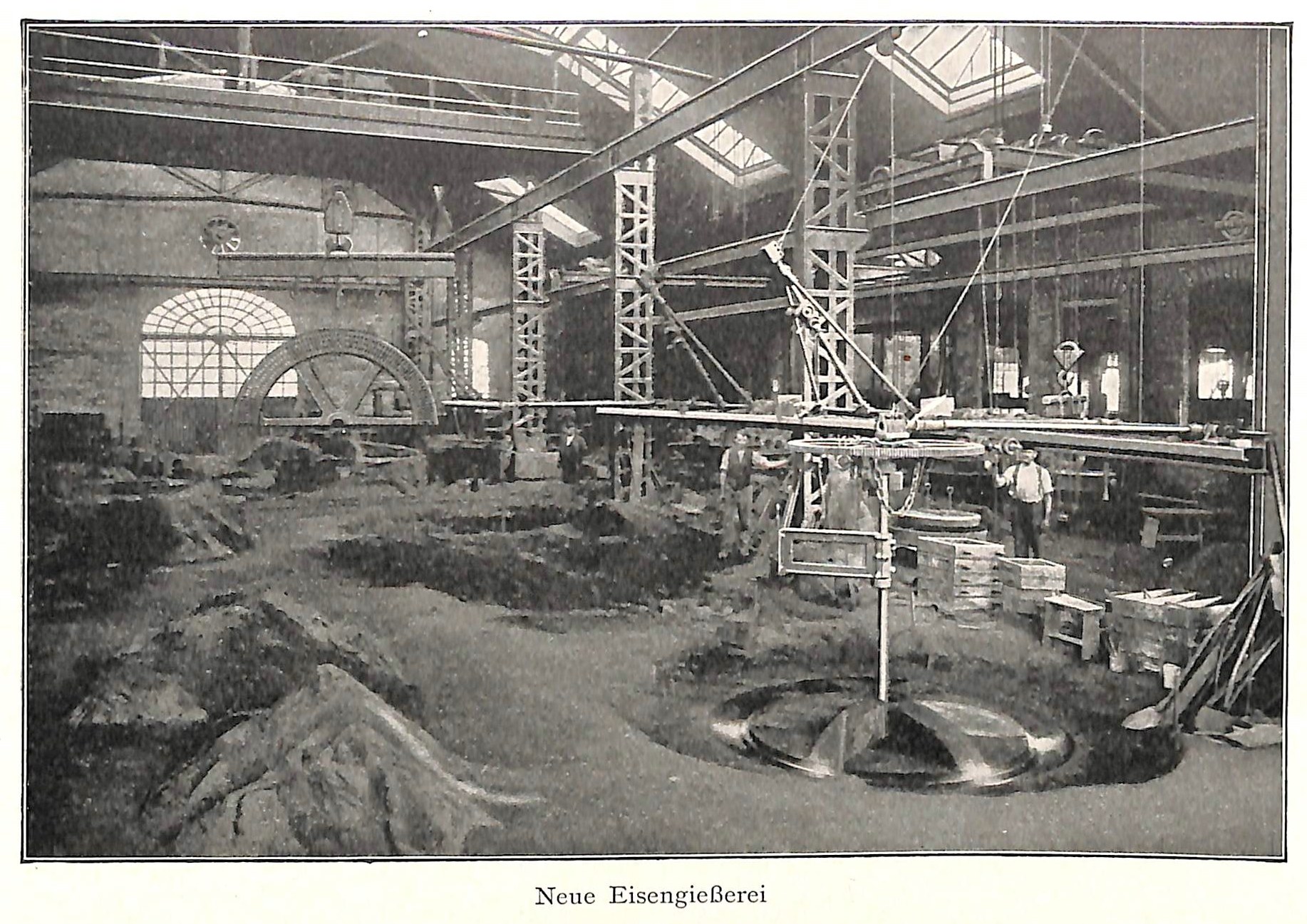Schwarz-weiß-Foto einer deutschen Fabrik aus dem 19. Jahrhundert mit Arbeitern, die Maschinen bedienen, umgeben von Metallstangen und -pfählen, beschriftet mit "Neue Eisenglebeerei, die erste Fabrik in Deutschland."