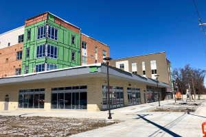 Großes mehrstöckiges Gebäude mit zahlreichen Fenstern, Teil des Campus der University of Wisconsin-Madison, umgeben von Straßeninfrastruktur und Bäumen unter einem bewölkten Himmel.